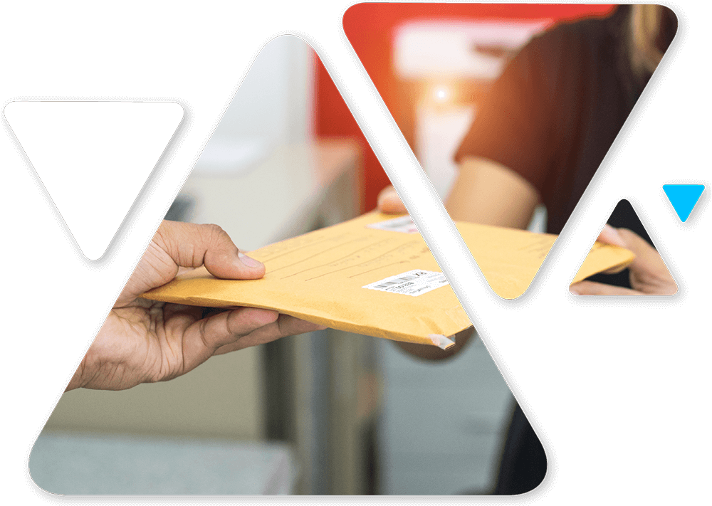 Person handing a padded manila envelope to another person at a desk in an office setting.