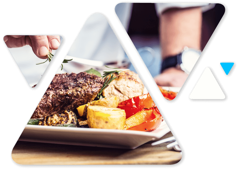 Plate with grilled steak, roasted potatoes and colorful peppers, garnished with rosemary, on a wooden table.